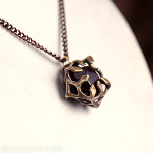 Unbound  -- Garnet Dodecahedron Caged in Bronze | Hibernacula